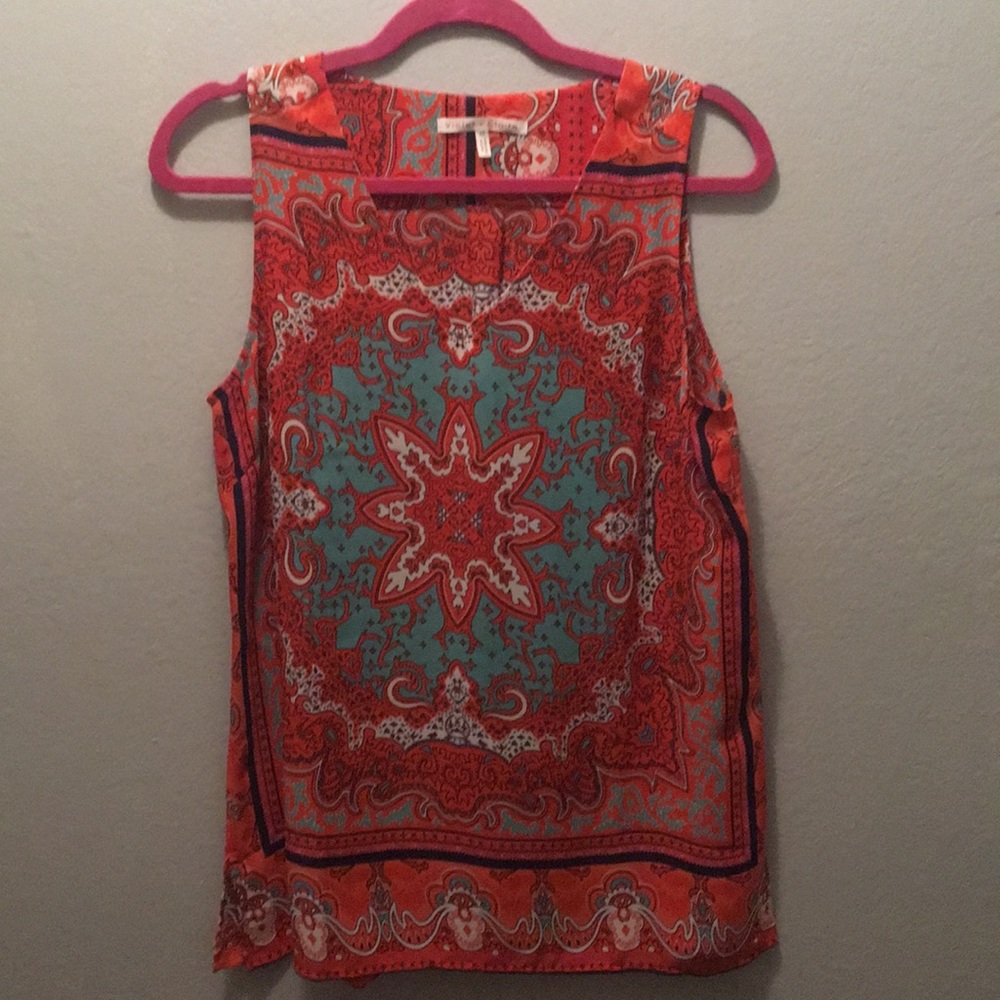 Sleeveless chiffon top with side slits.